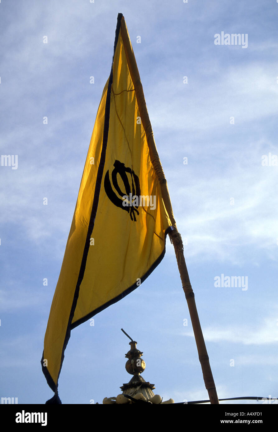 A saffron flag known as the Nishan Sahib flies over every Sikh gurudwara or place of worship. Stock Photo