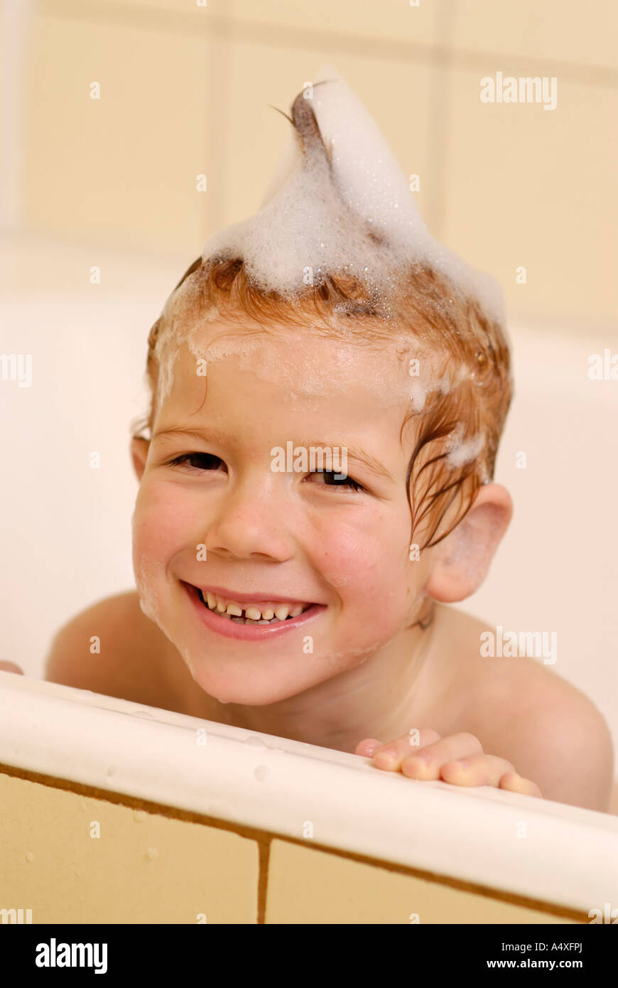 Child in the bathroom having a foam bath Stock Photo Alamy