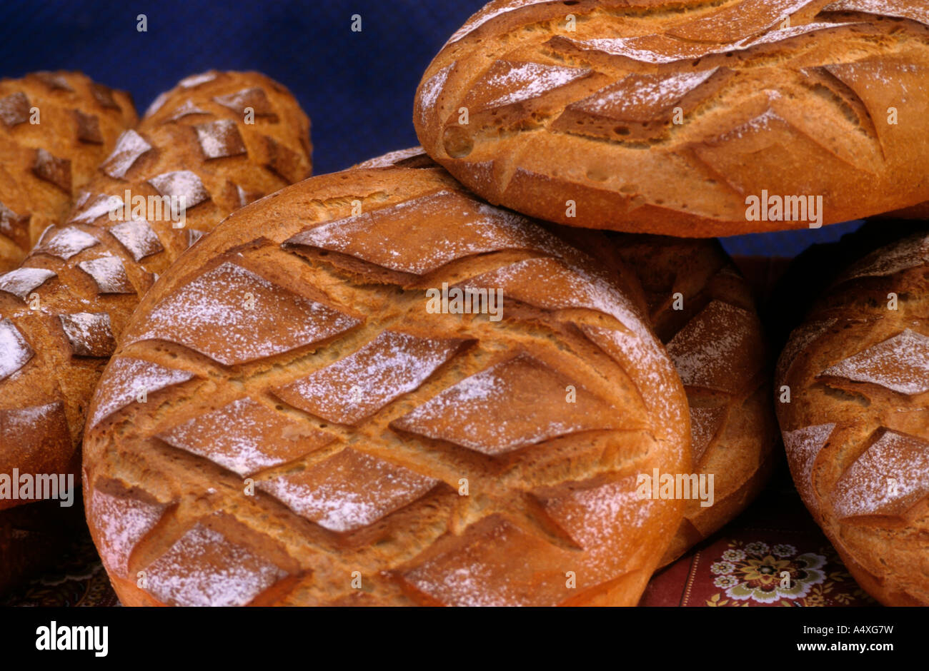 Piles of freshly baked loaves of artisan bread, France Stock Photo