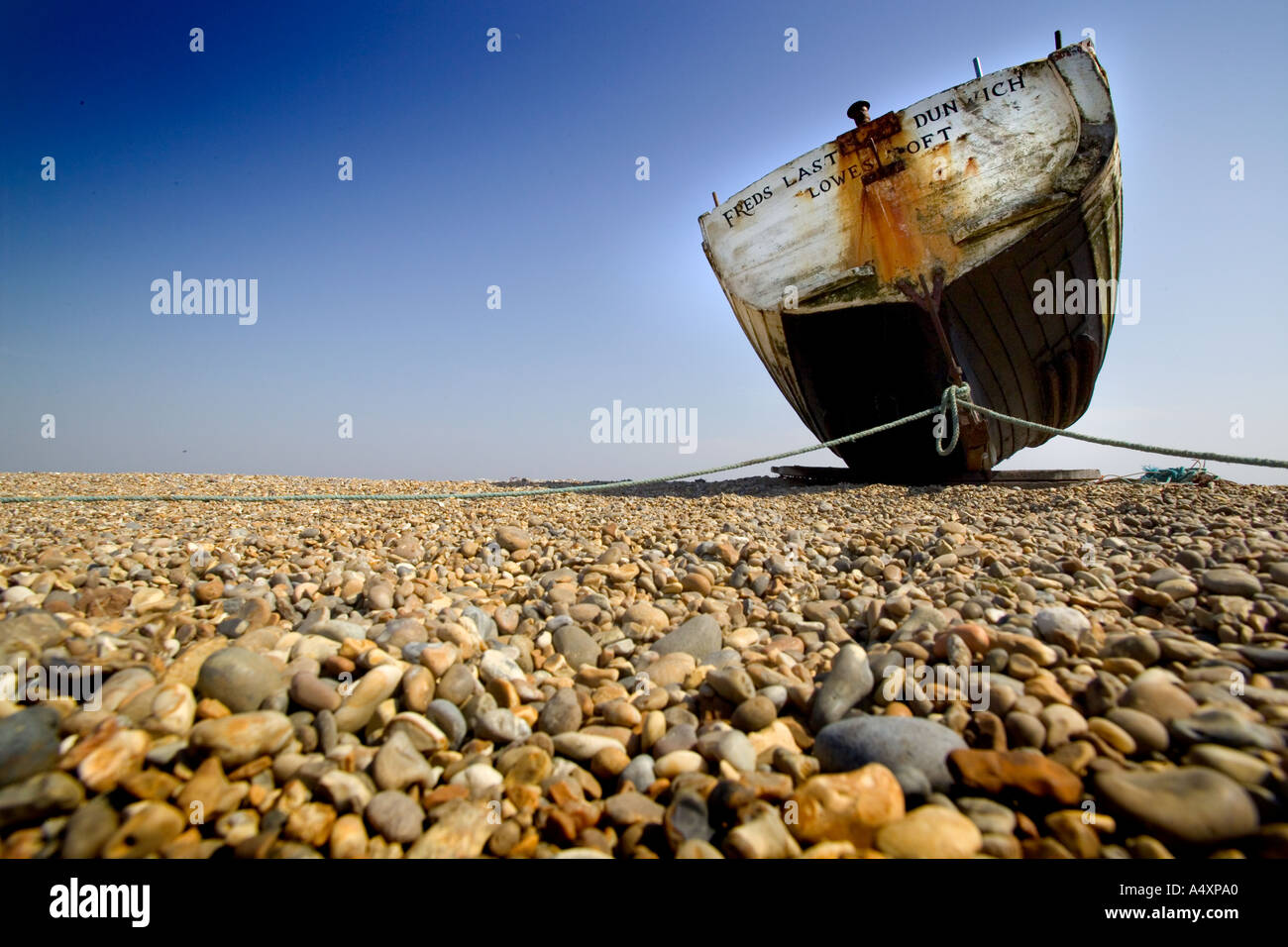 Old fishing boat on shingle beach at Dunwich Suffolk England UK Stock ...