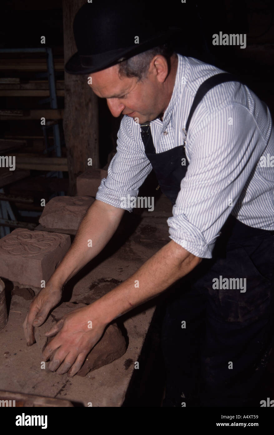 Colin Richards making bricks by hand working the clay before putting it in the mould Stock Photo
