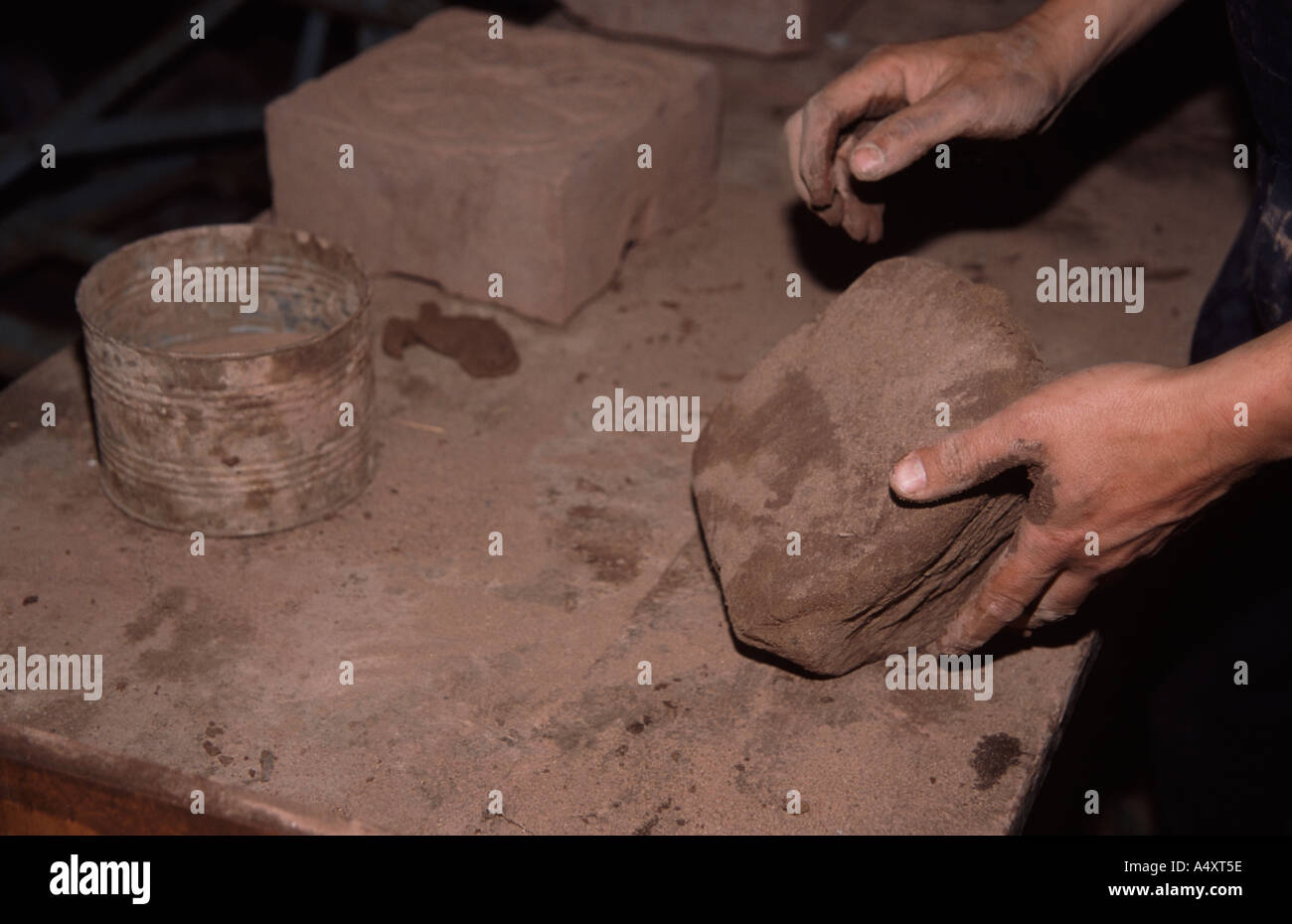Colin Richards making bricks by hand working the clay before putting it in the mould Stock Photo