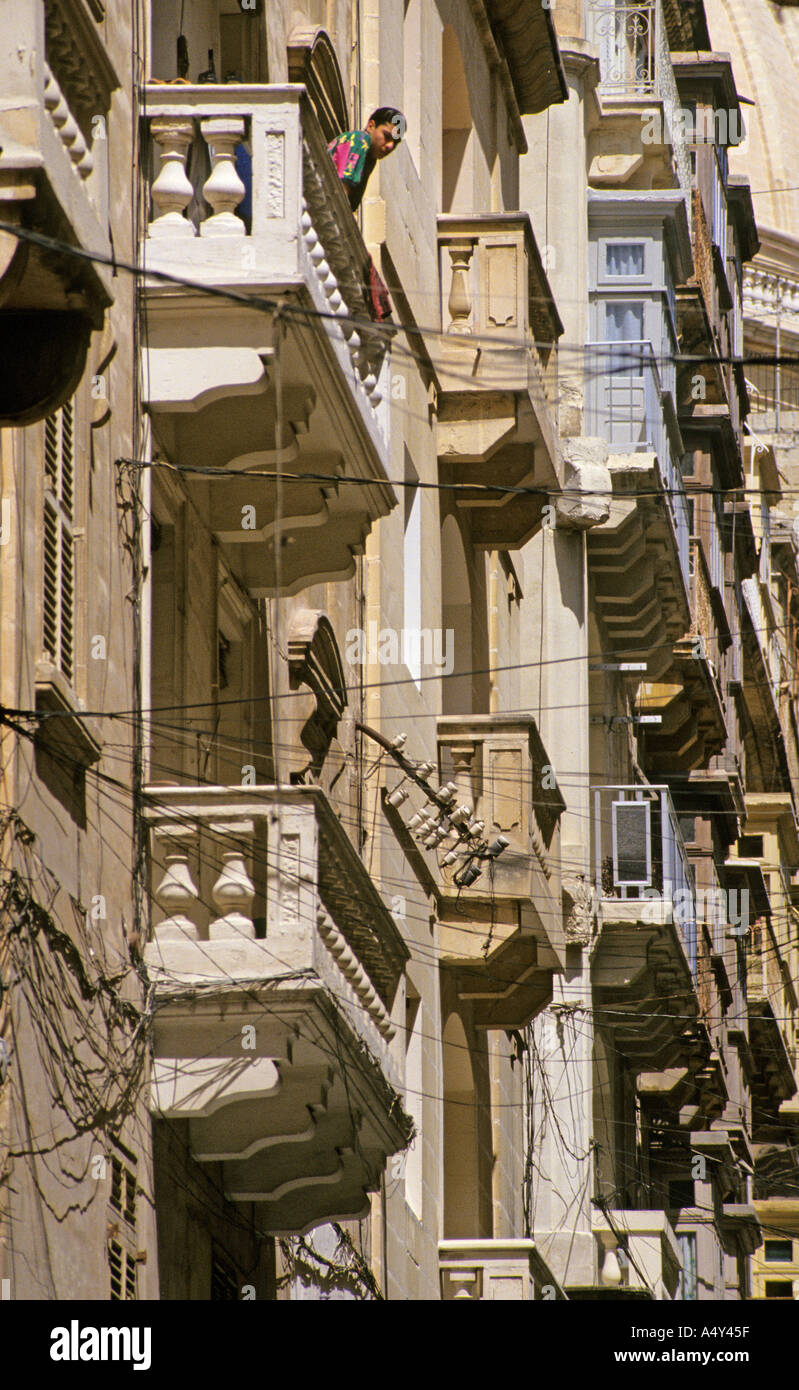 Man on balcony overlooking street Valletta Malta Stock Photo