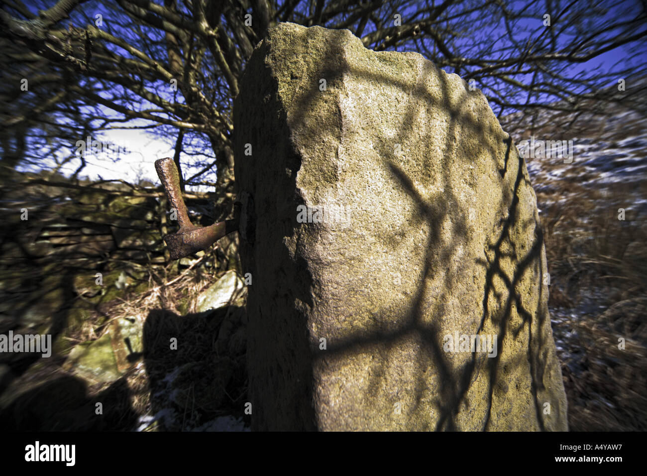 Remains of gate post and iron hinge next to the remains of former workers cottages at Croston Close Upper Mill Stock Photo