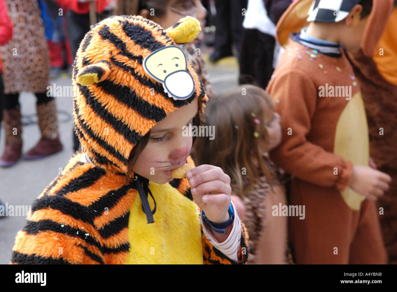 Young boy dressed as a tiger in the Carnival of Ibiza, eating chips Stock Photo