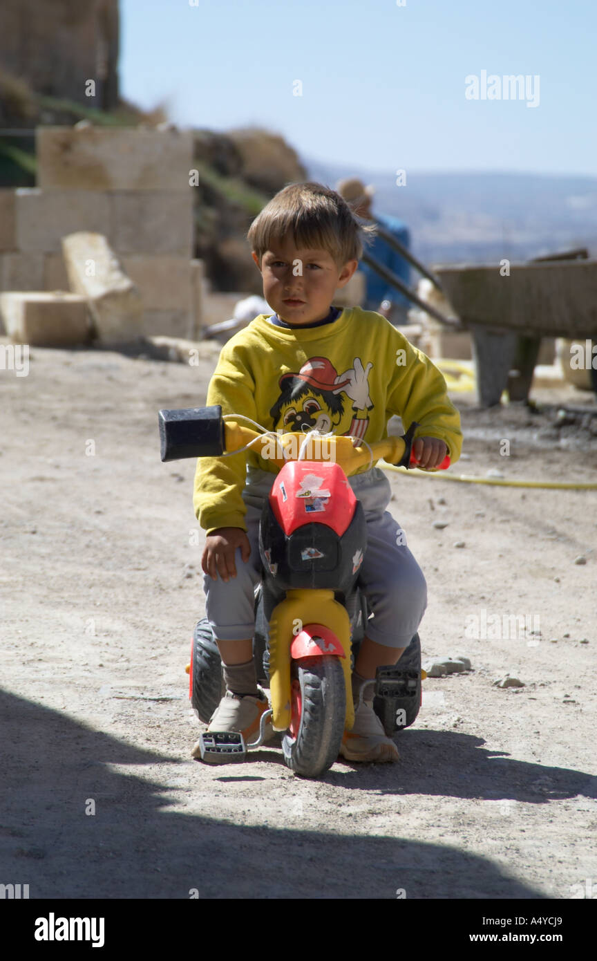 Turkish boy riding tricycle in Cappadocian town in Turkey Stock Photo ...