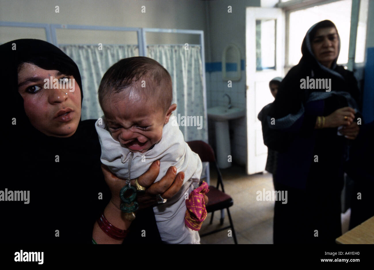 A mother with her child at Maiwand Hospital Plastic Surgery Unit The little one was born with a cleft palate Stock Photo