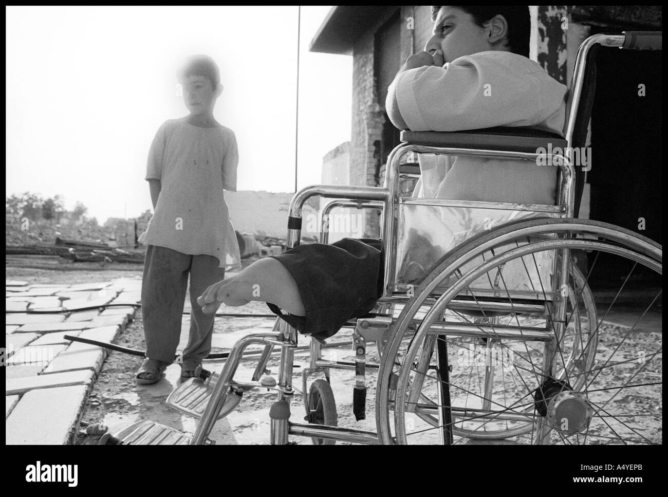 Handicaped boy with brother, Kirkuk Stock Photo