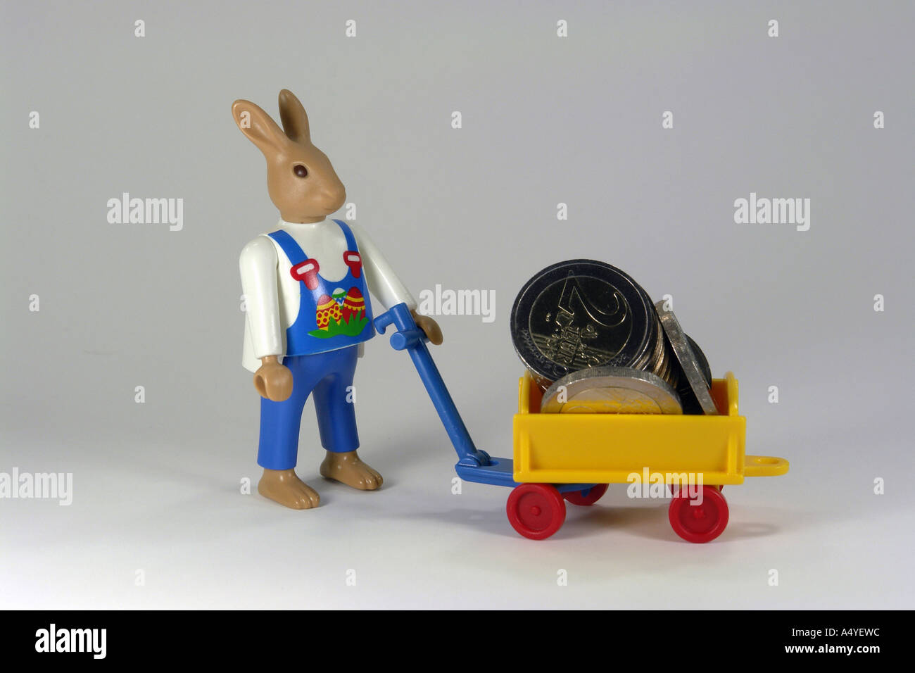 Easter bunny with euro coins as symbole for expensive easter shopping Stock Photo