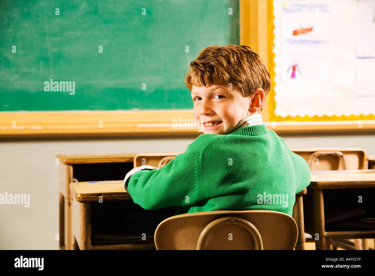 Portrait of boy at desk in classroom Stock Photo - Alamy