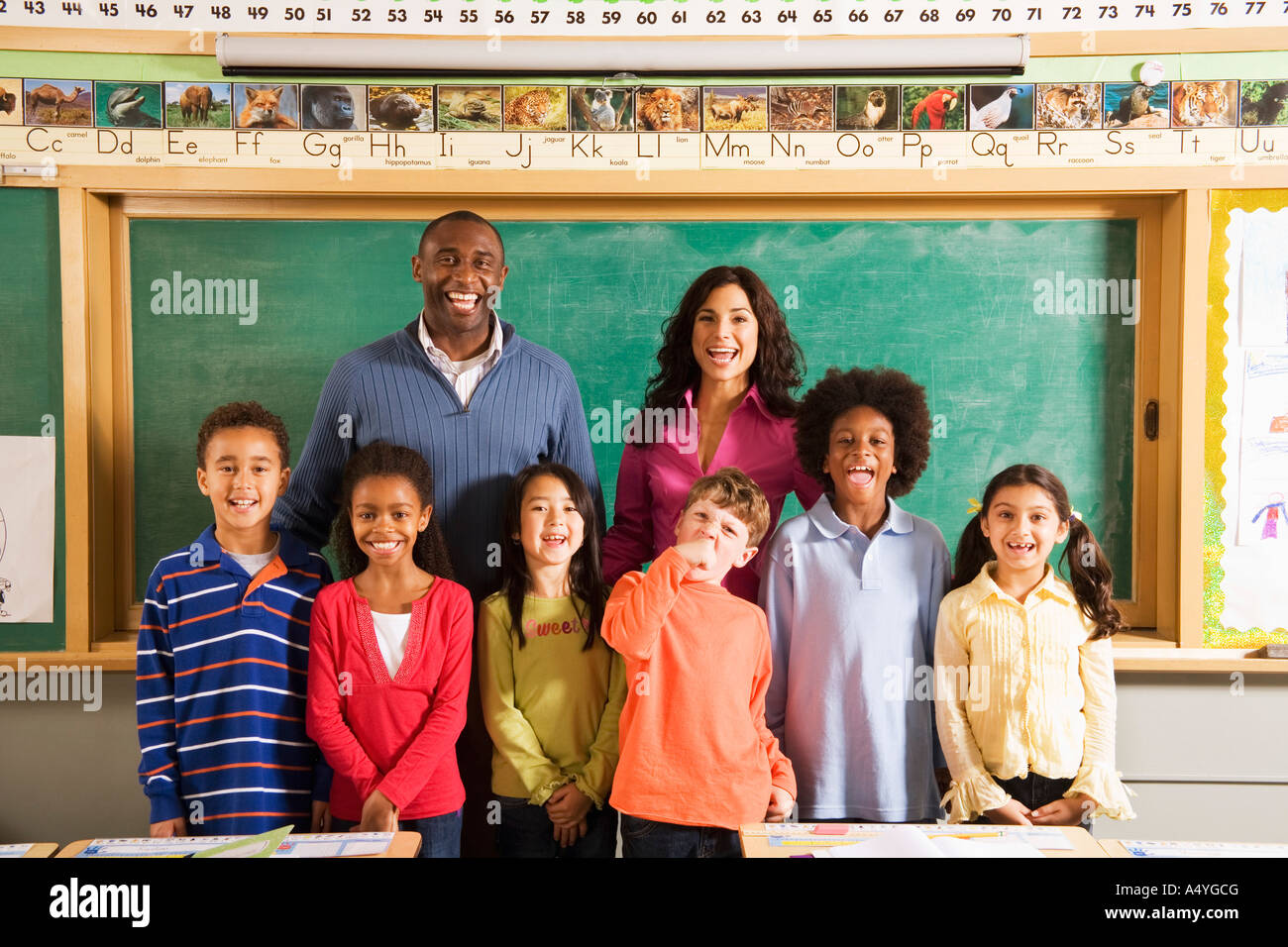 Portrait of teachers and students in classroom Stock Photo