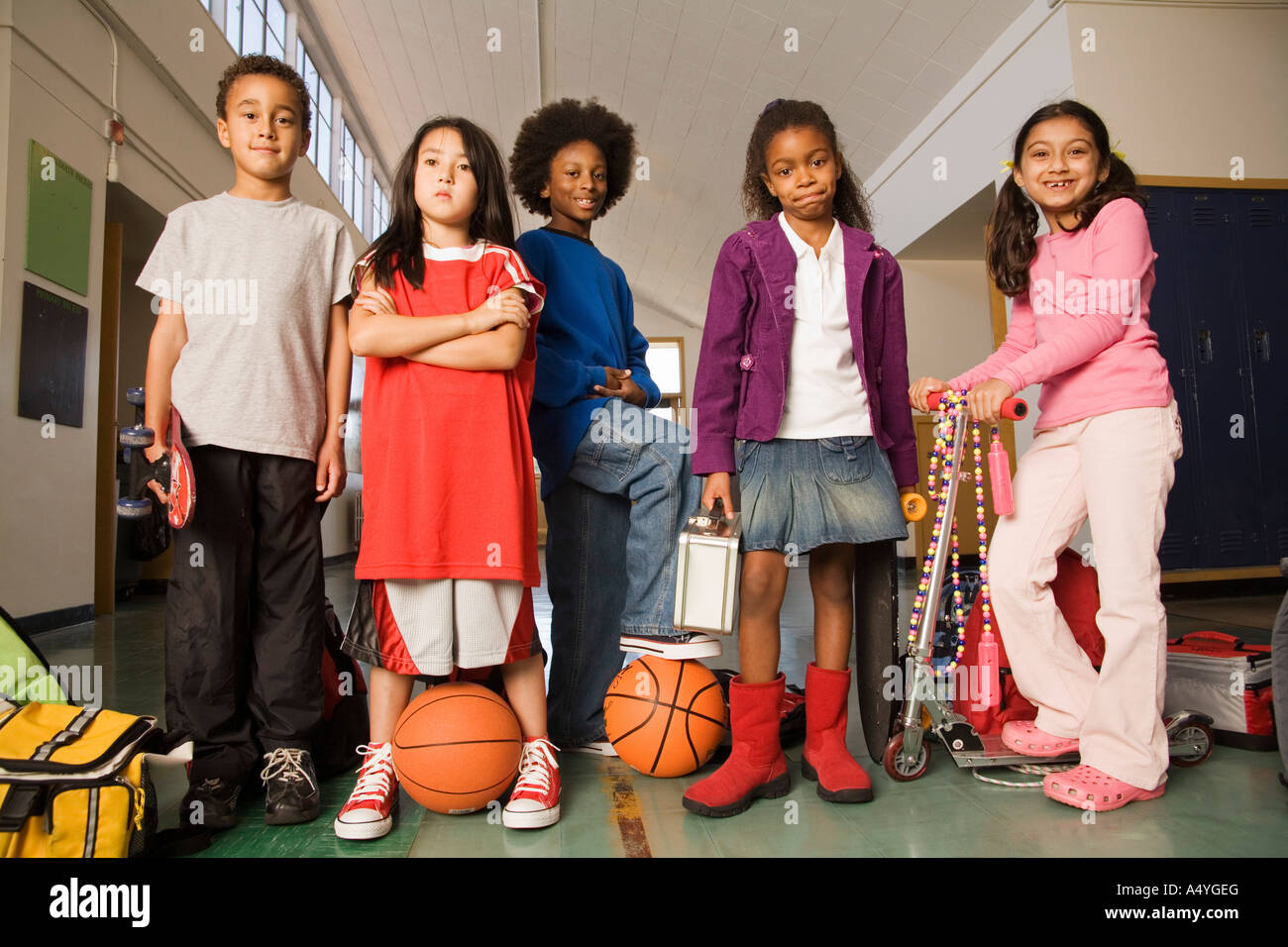 Group of students with sports equipment in hallway Stock Photo Alamy