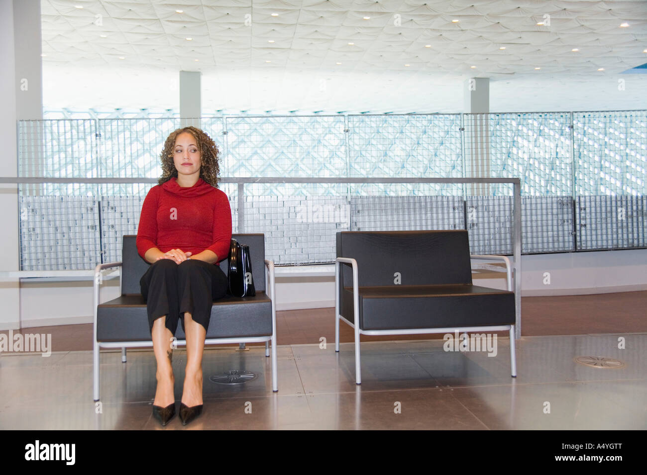 Woman waiting in chair Stock Photo
