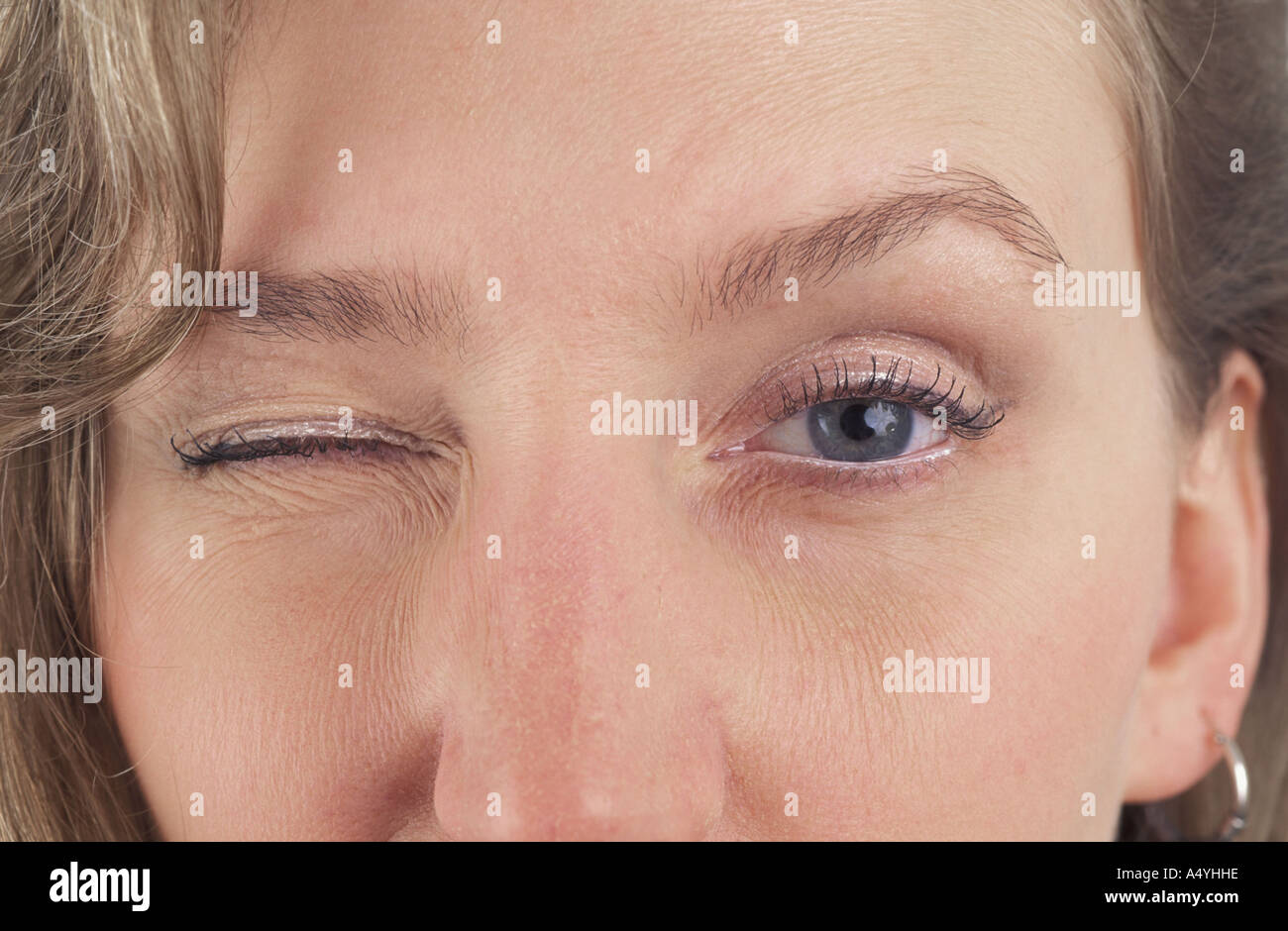 Blond woman blinking Stock Photo