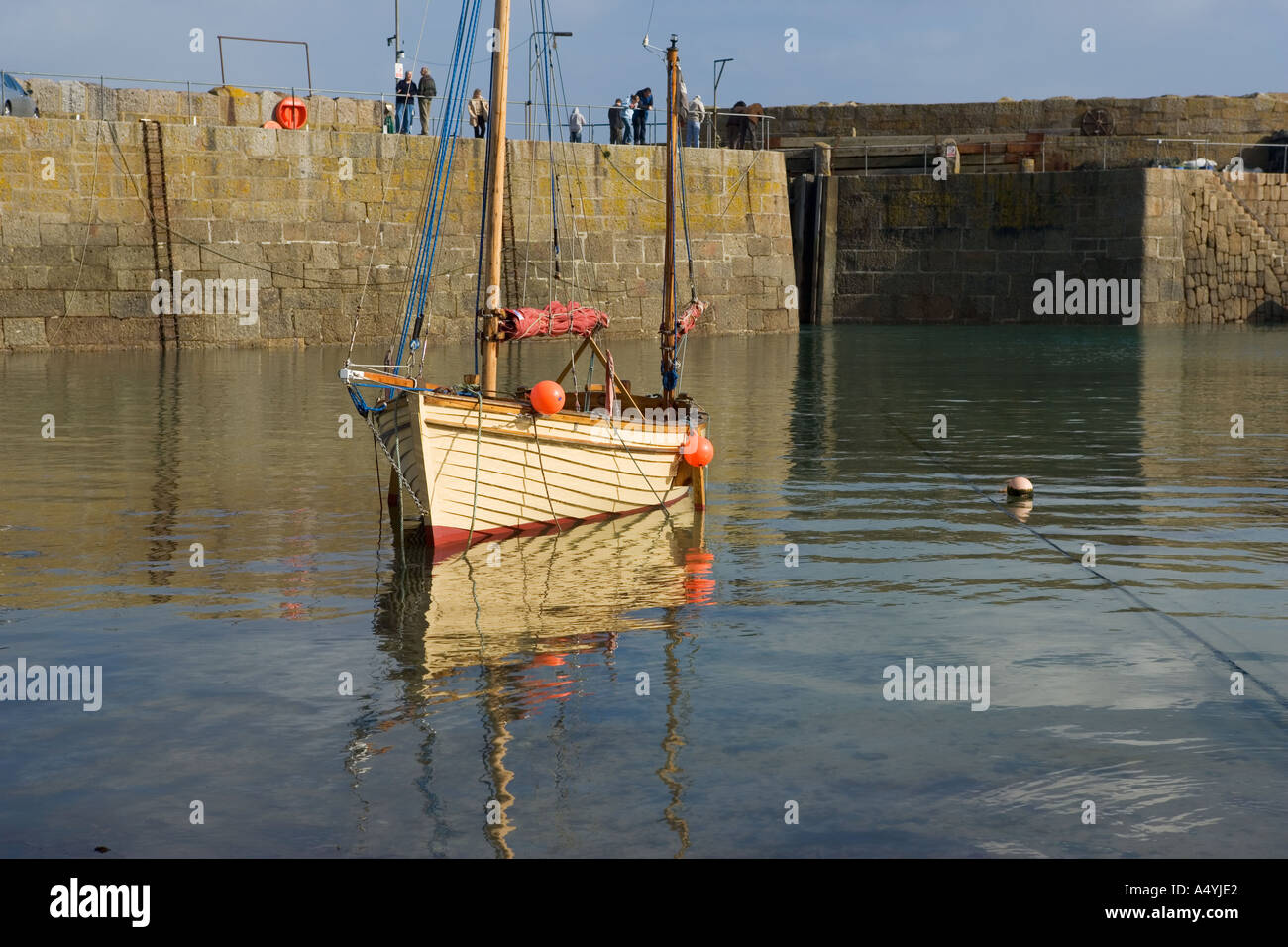 traditional sailpowered fishing boat in mousehole harbour cornwall Stock Photo