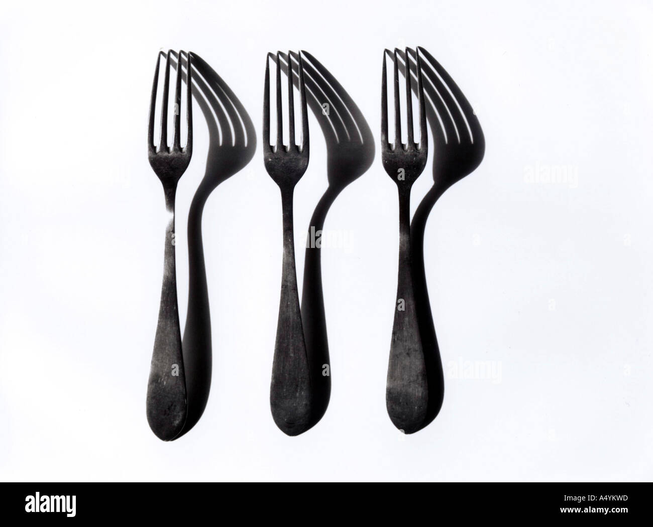 Three forks and their shadows Stock Photo Alamy