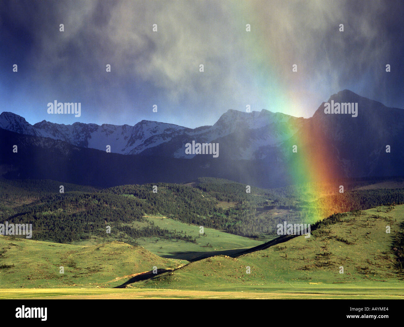 Thunderstorm with rain and rainbow Absaroka Mountains and Sleeping Giant formation near Livingston Montana USA Stock Photo