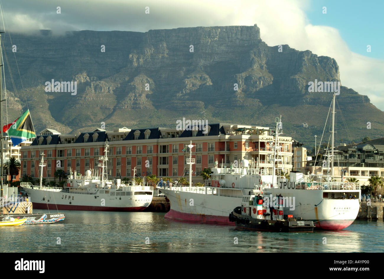 Victoria and Alfred Waterfron working and leisure complex Cape Town South Africa Tug berthing fishing boat Stock Photo