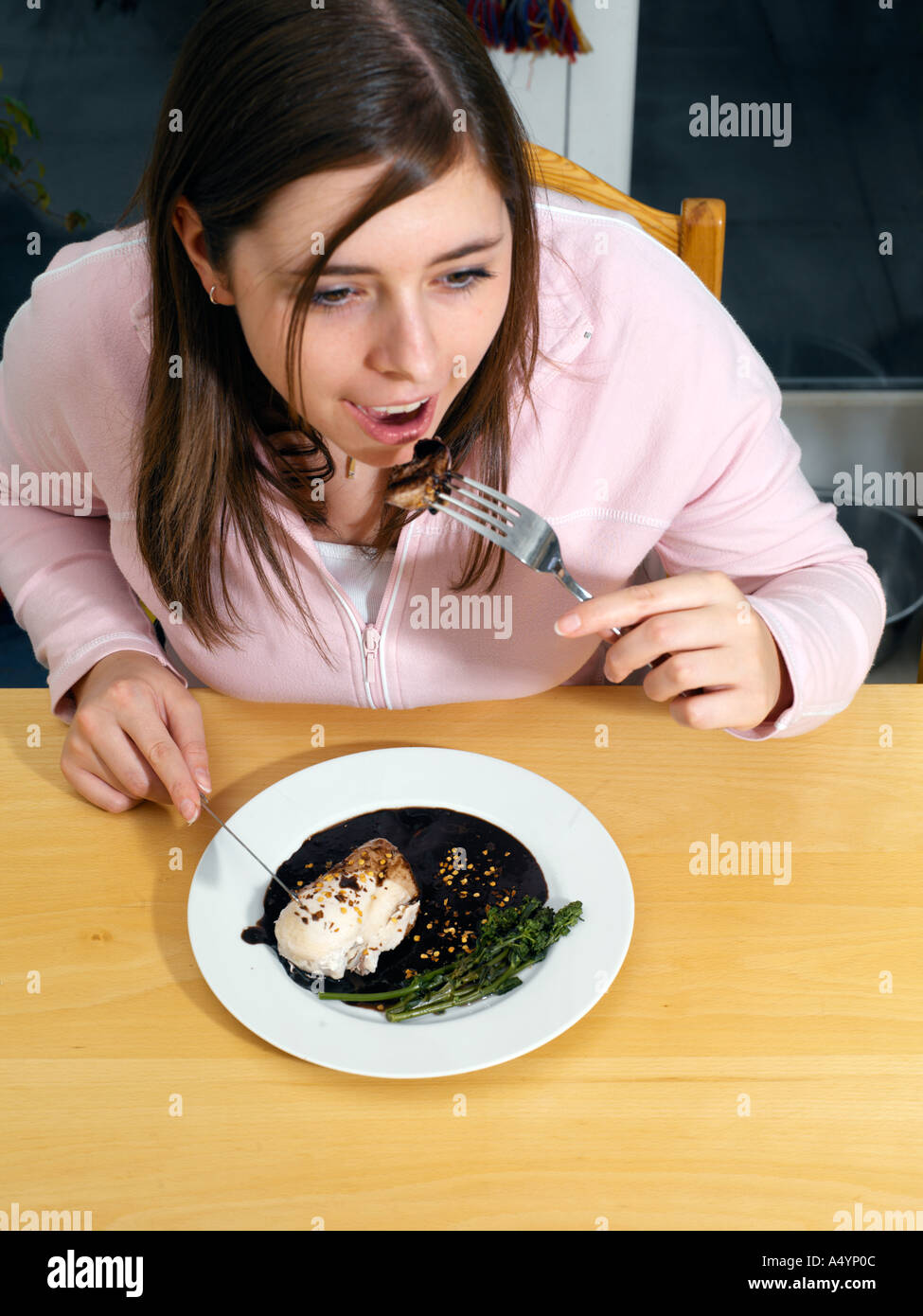 Young Woman Eating Mexican Dish Mole Poblano Chicken with Chocolate and