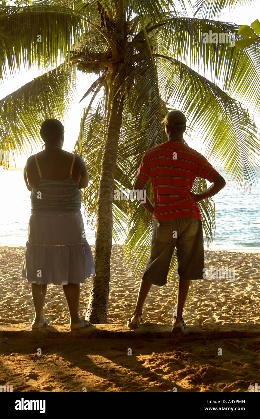 Couple of Dominican watching the sunset on the Sosua beach Stock Photo