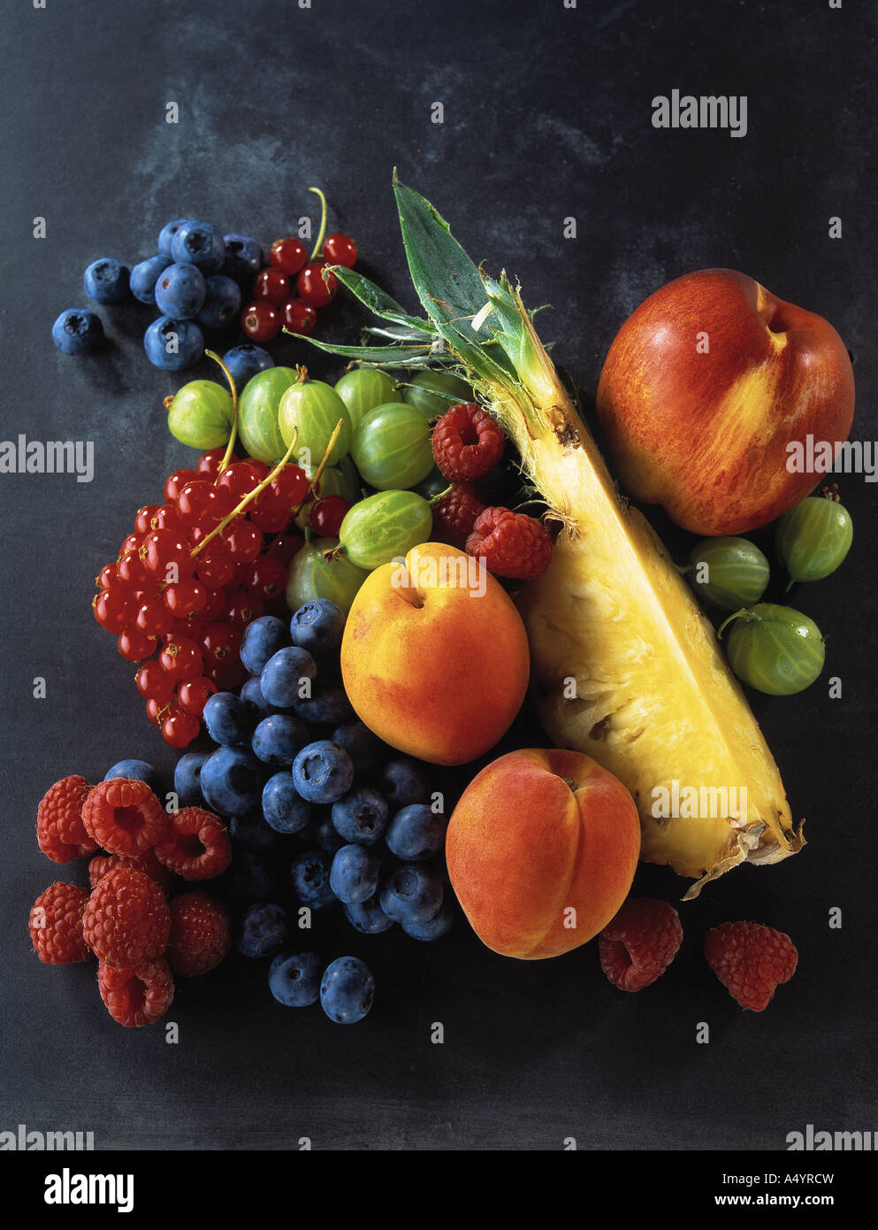 Selection of various fresh fruits on a slate background Stock Photo
