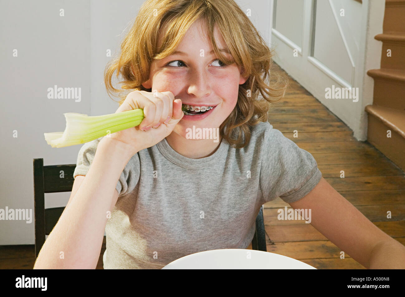 Girl biting a celery stick Stock Photo