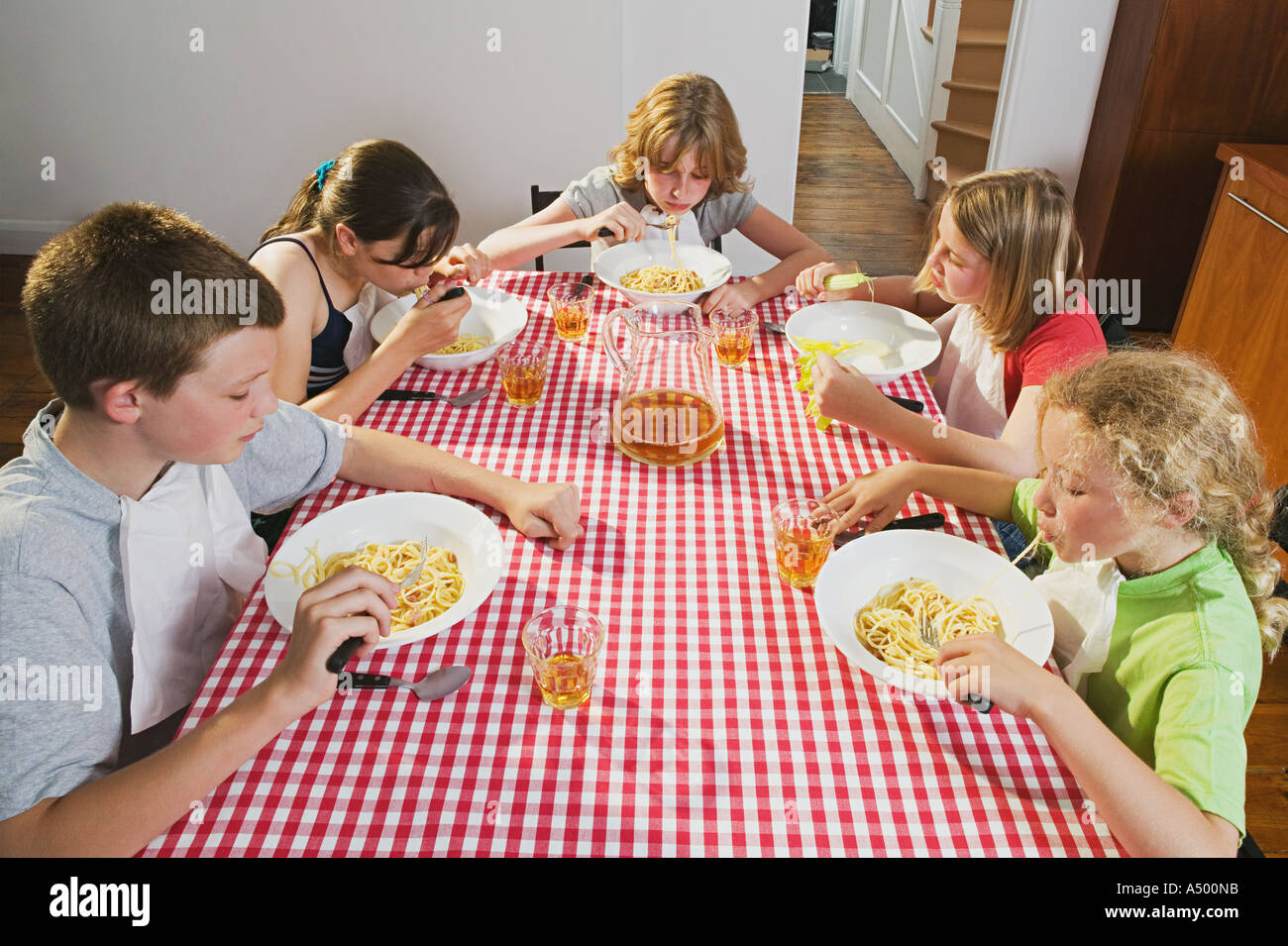 Children eating spaghetti Stock Photo
