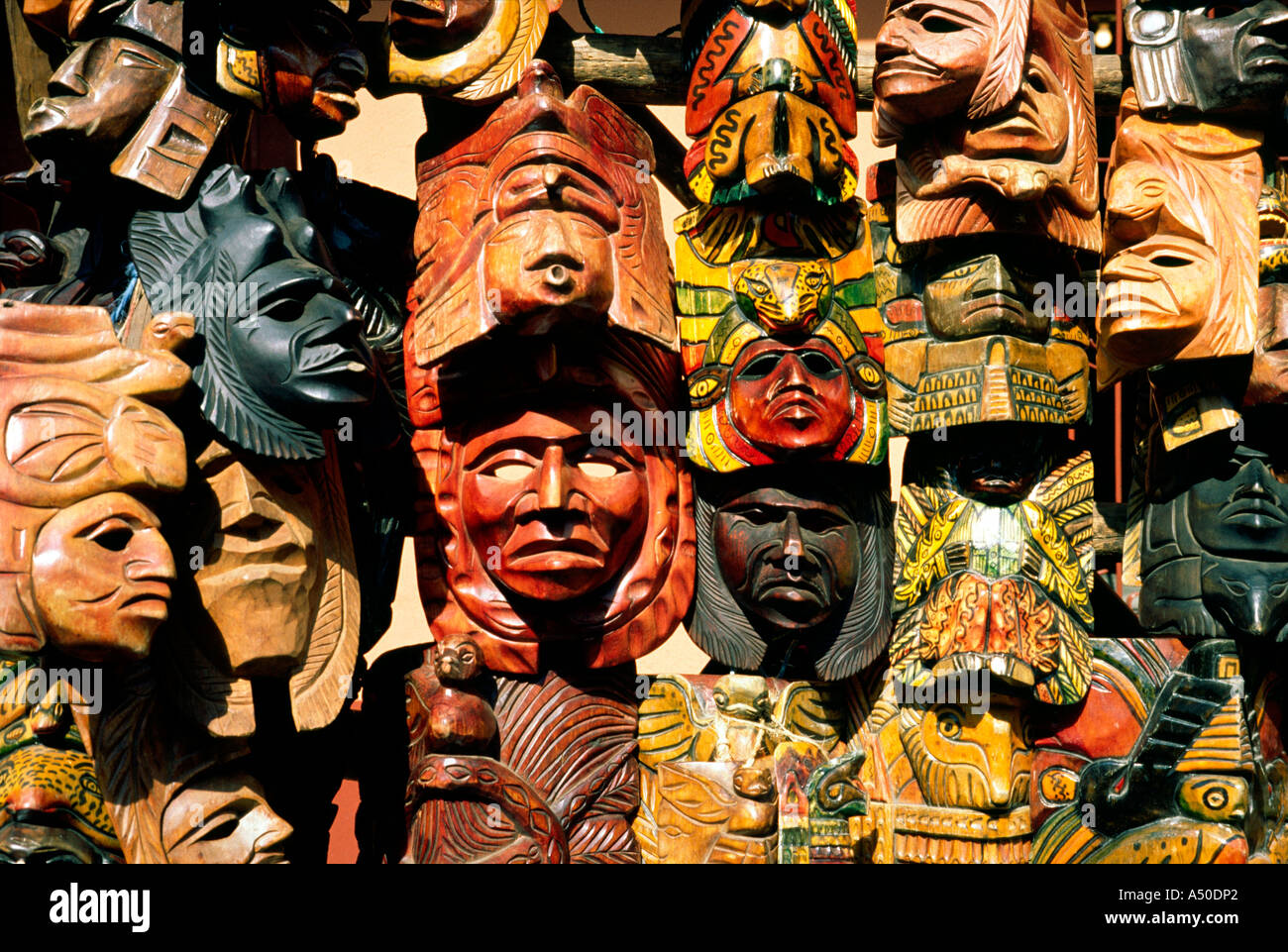 Mayan handcrafted wooden masks used for traditional dancing on sale at the weekly market of Chichicastenango in Guatemala. Stock Photo