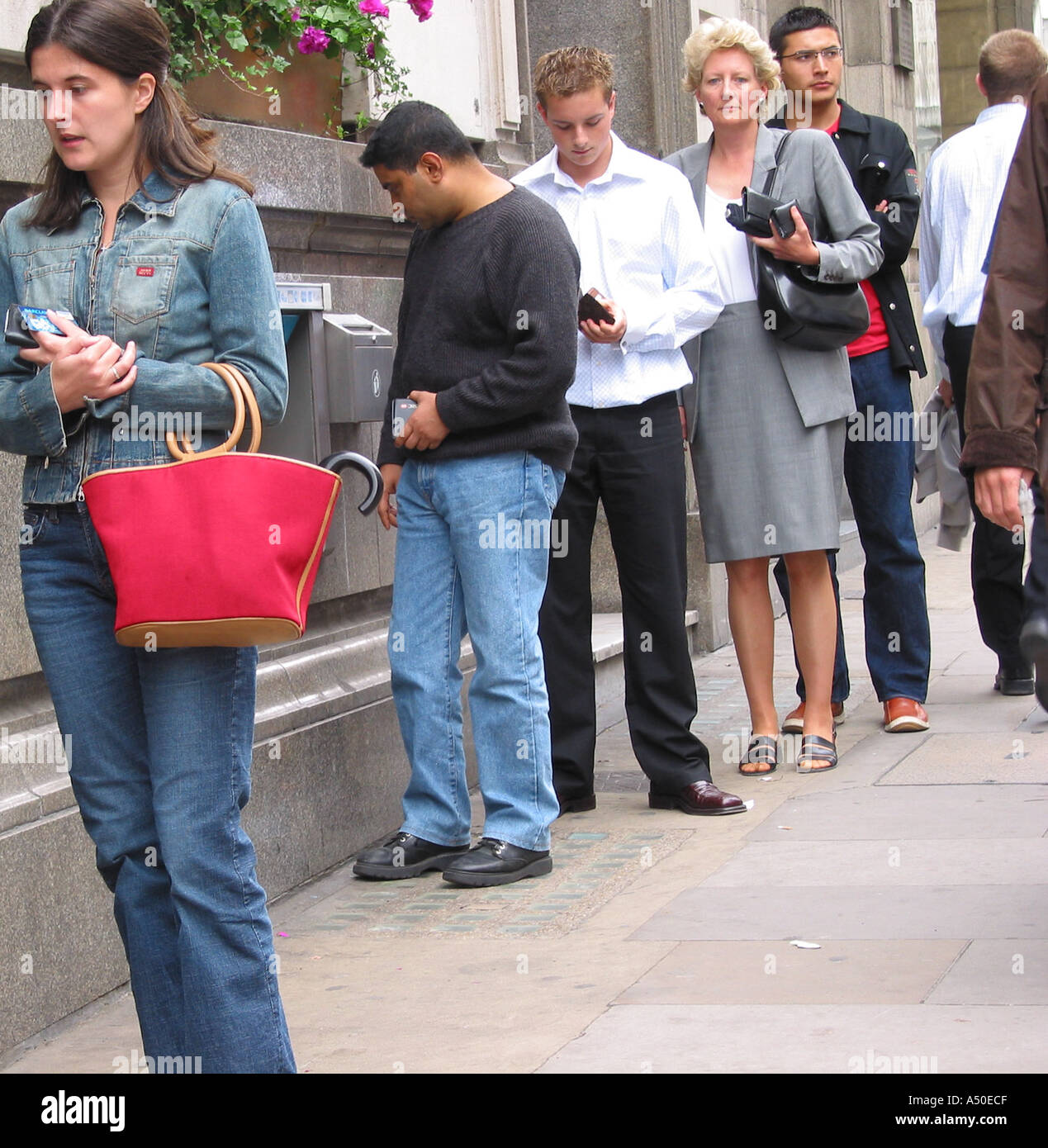 Queue of People at a Cash ATM Machine Stock Photo