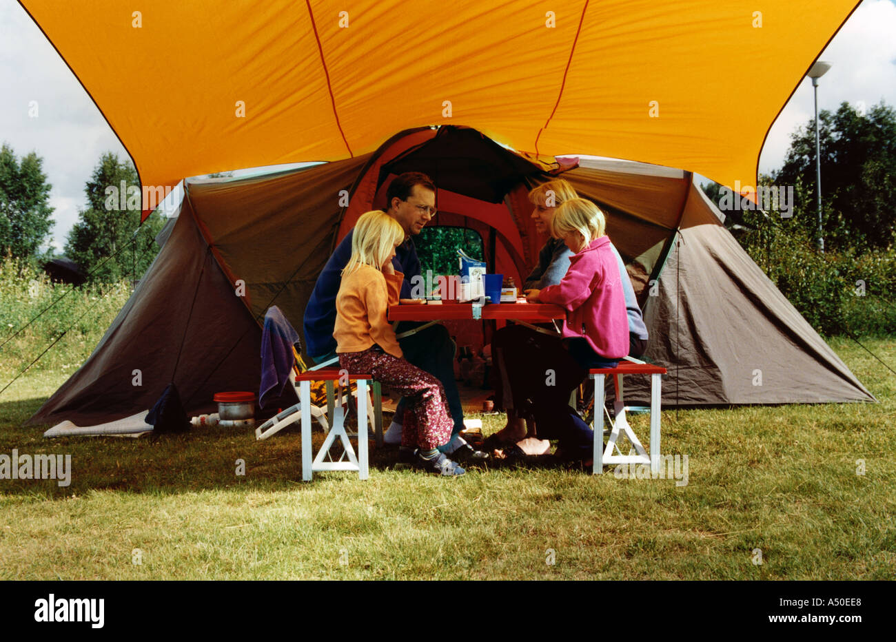 Family eating in front of their tent 