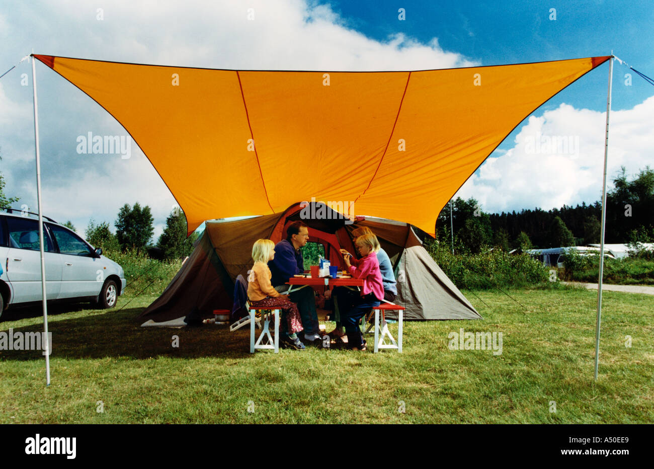 camping family outside their tent Stock Photo