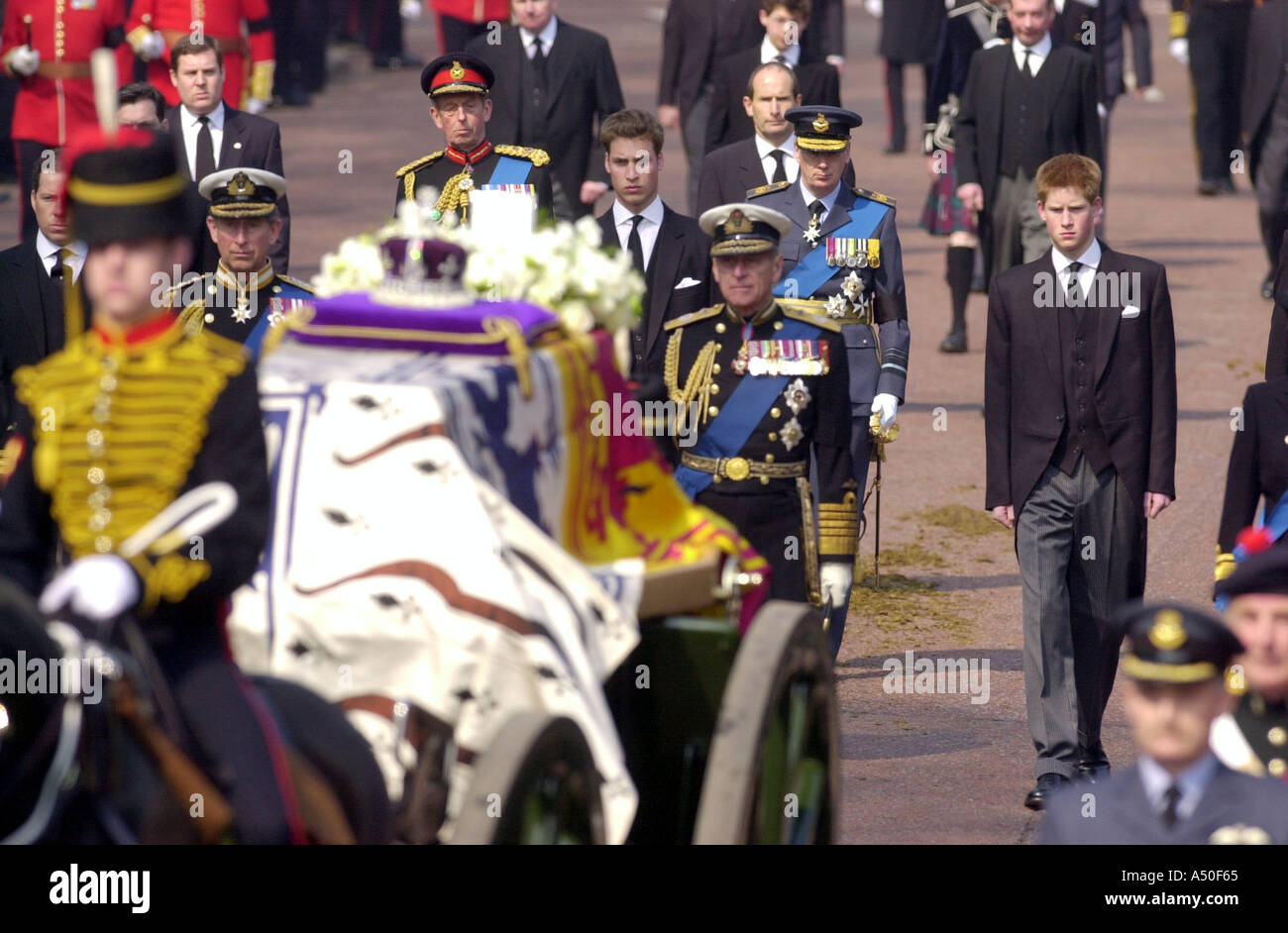 Prince Charles Prince William and Prince Harry march solemnly behind the Queen Mothers coffin during her funeral procession Stock Photo