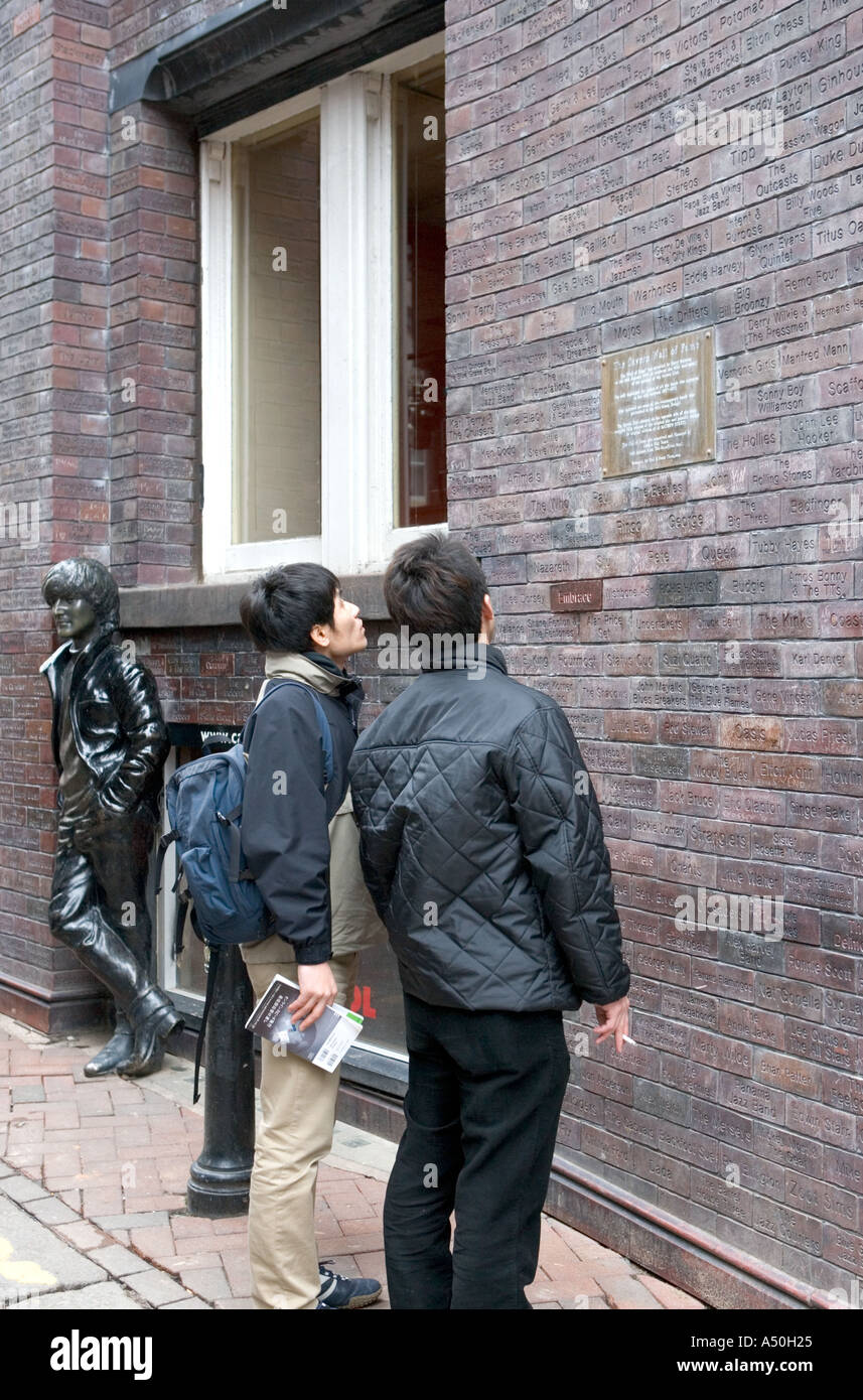 Tourists view the Cavern Club Wall of Fame Liverpool England Stock Photo