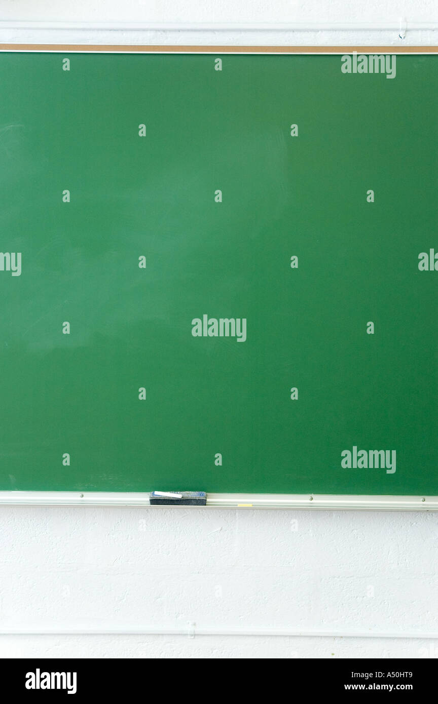 Old school blank chalkboard and eraser in a classroom Stock Photo Alamy