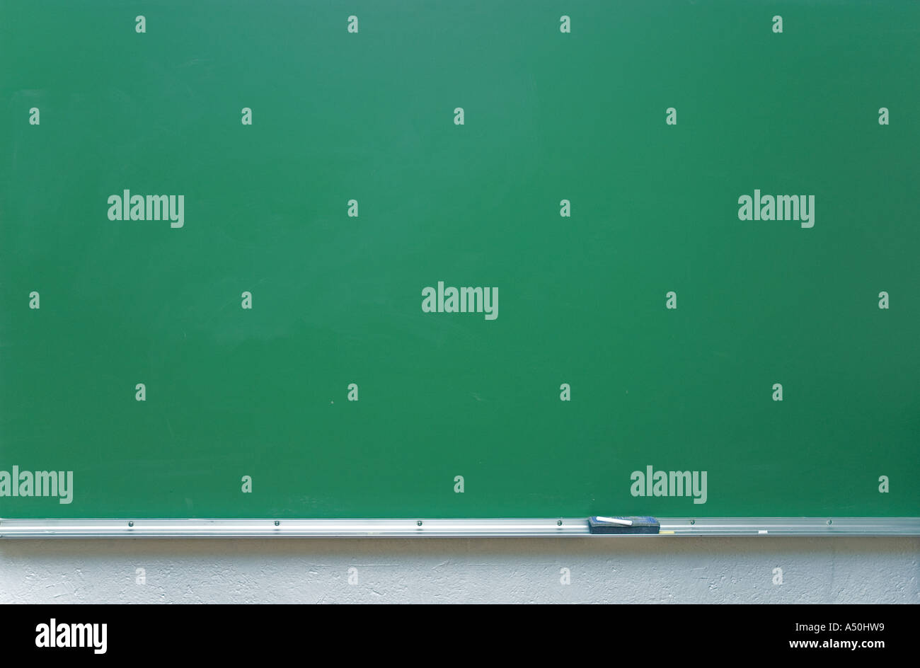 Education or back to school Concept. glasses, pencils, note books, chalk,  eraser over chalkboard background. Stock Photo