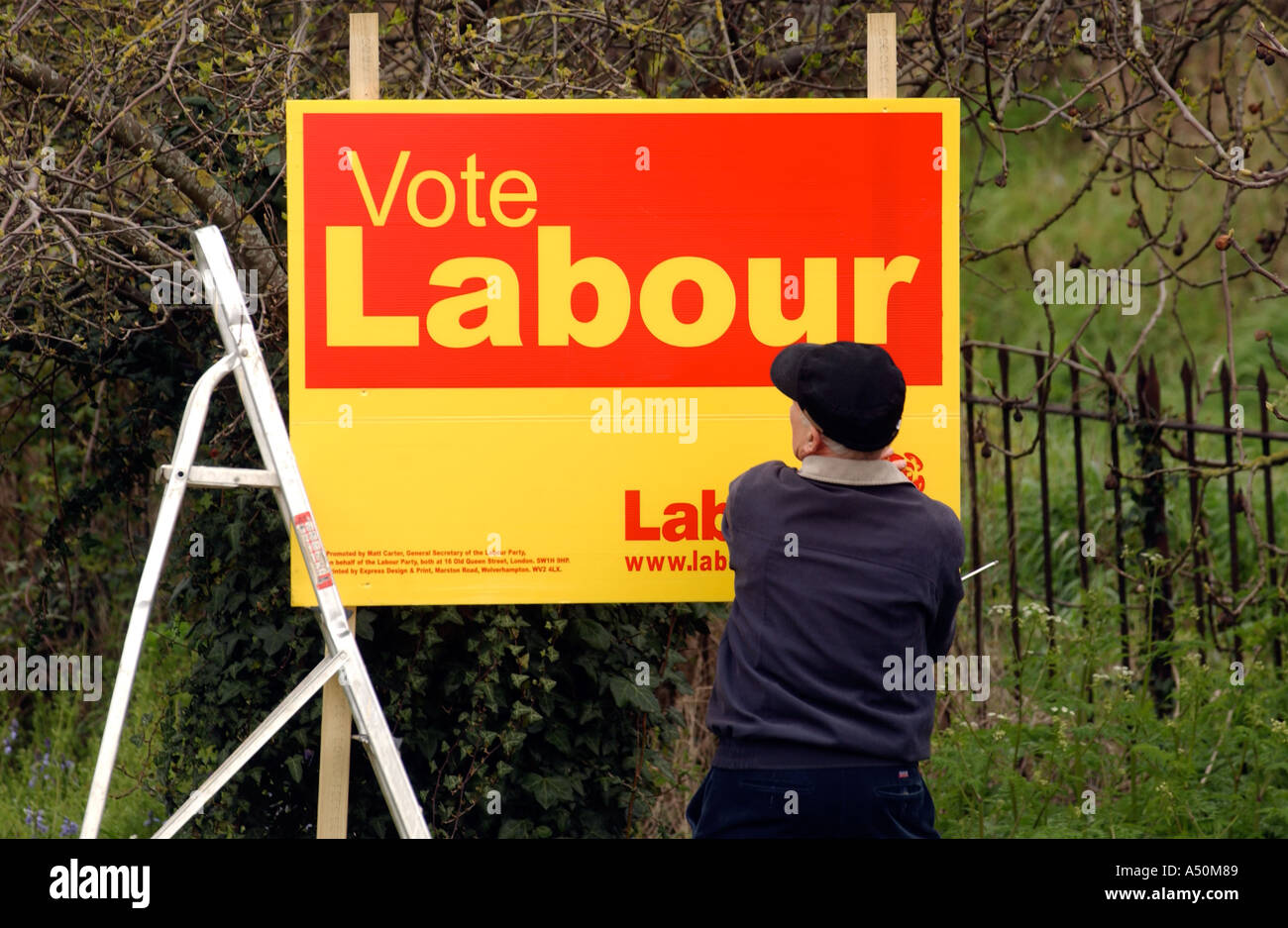 A Labour poster being put up Stock Photo Alamy