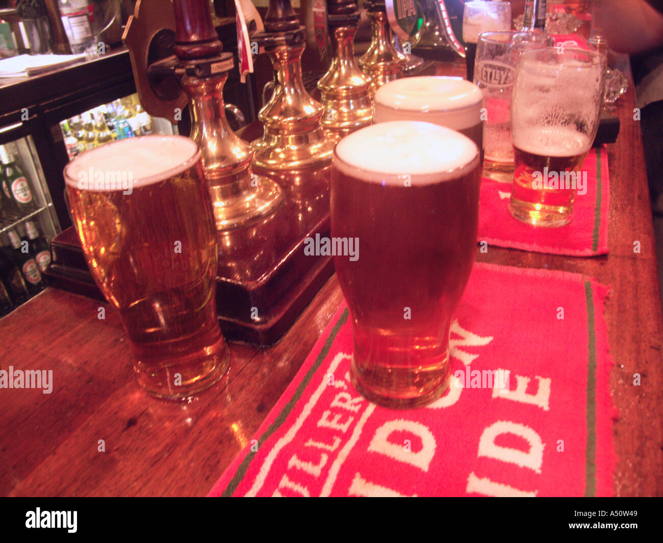 Pints of beer on the bar London pub interior England Stock Photo