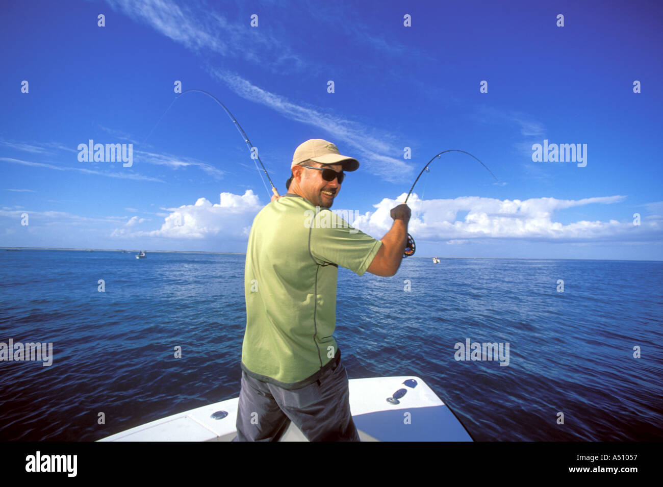 Man fly fishing off of boat bow in North Carolina USA Stock Photo Alamy