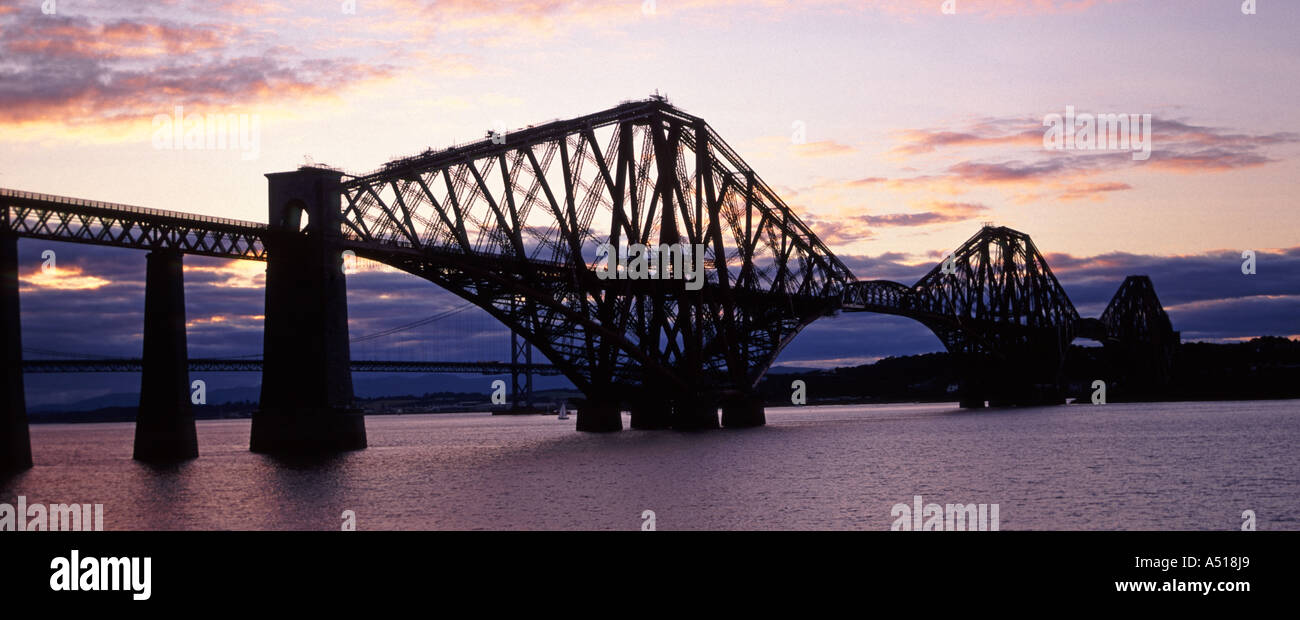 Historical Victorian Scotland Firth of Forth steel cantilever rail bridge in silhouette at sunset South Queensferry view towards North Queensferry UK Stock Photo
