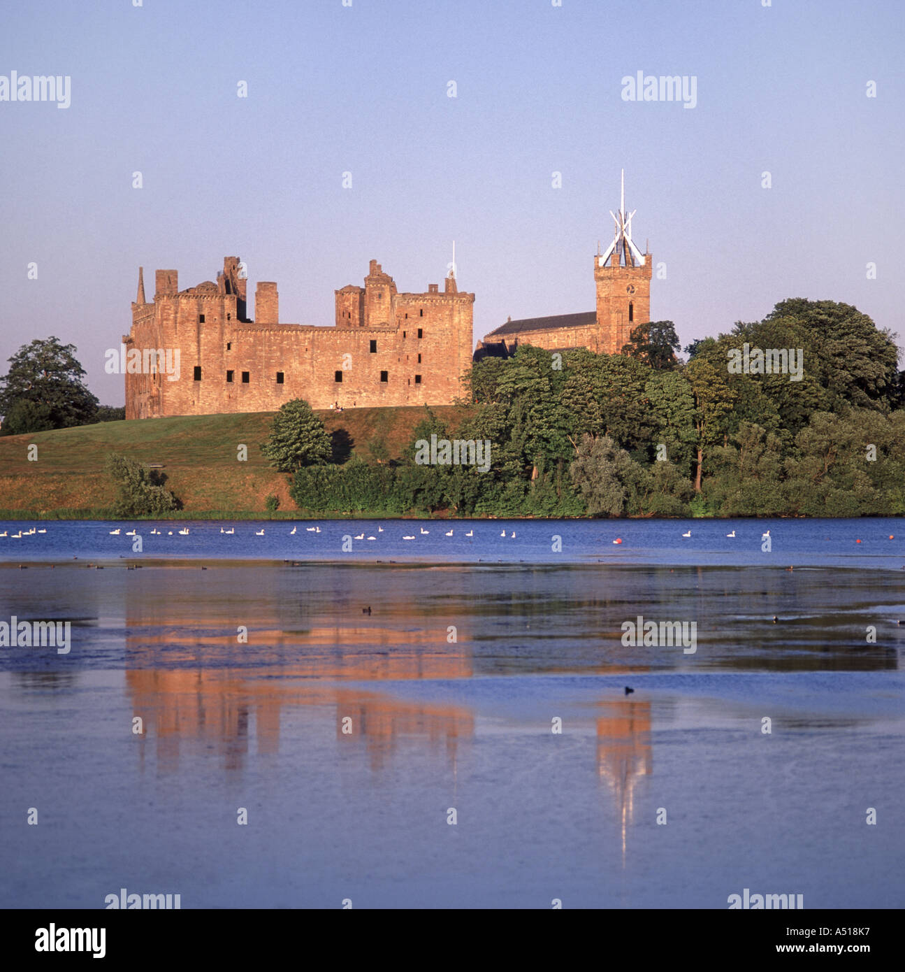Linlithgow Loch the ruined Palace with the tower of St Michaels Church beyond Stock Photo