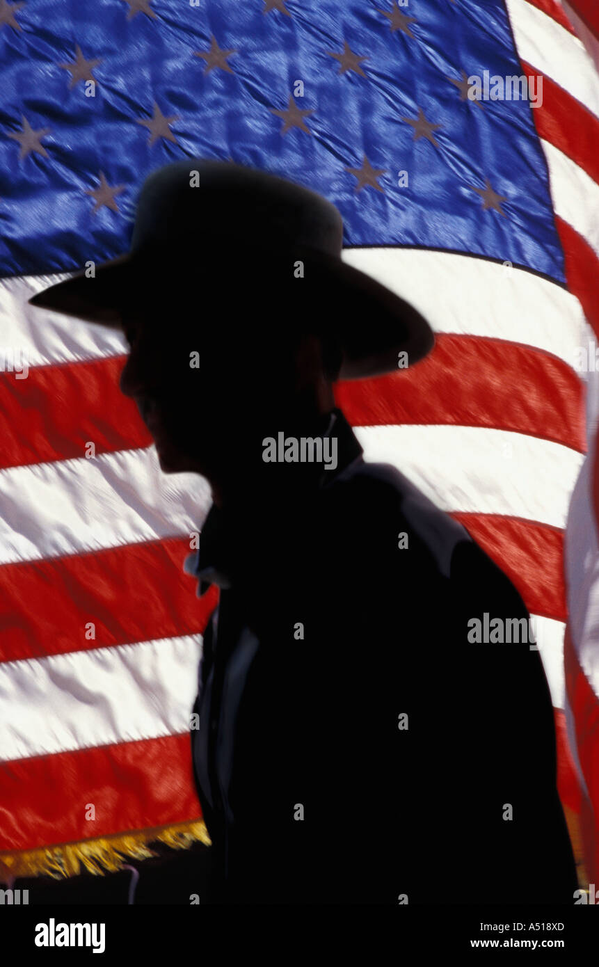 Silhouette of a cowboy against the American flag Stock Photo