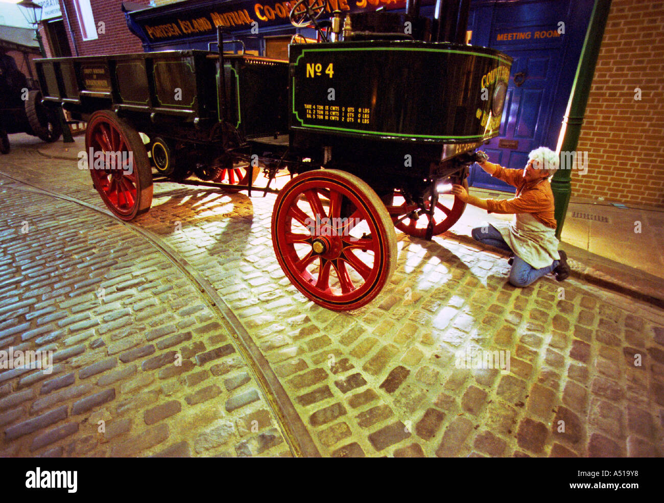 Painter Michael Doherty prepares a 1902 Thornycroft 4 ton steam lorry for exhibition. Stock Photo