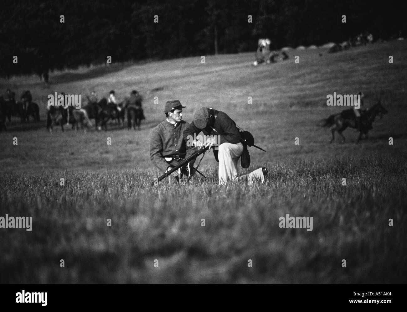 Black and white photo of our union army soldier with a wounded comrade during the Battle of Gettysburg reenactment Stock Photo