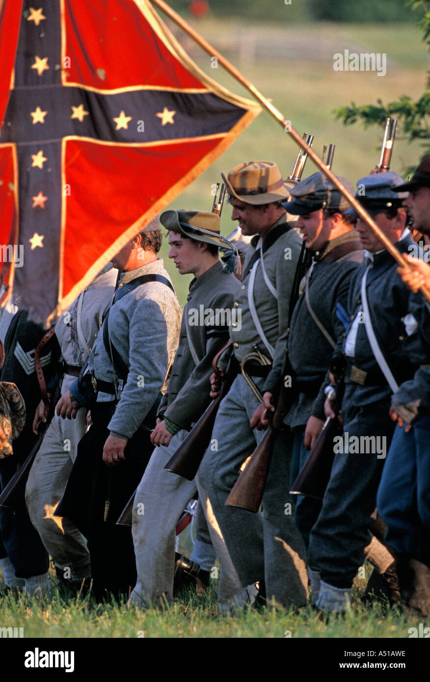Confederate soldiers marching under the Confederate battle flag during the Gettysburg Civil War battle reenactment Stock Photo