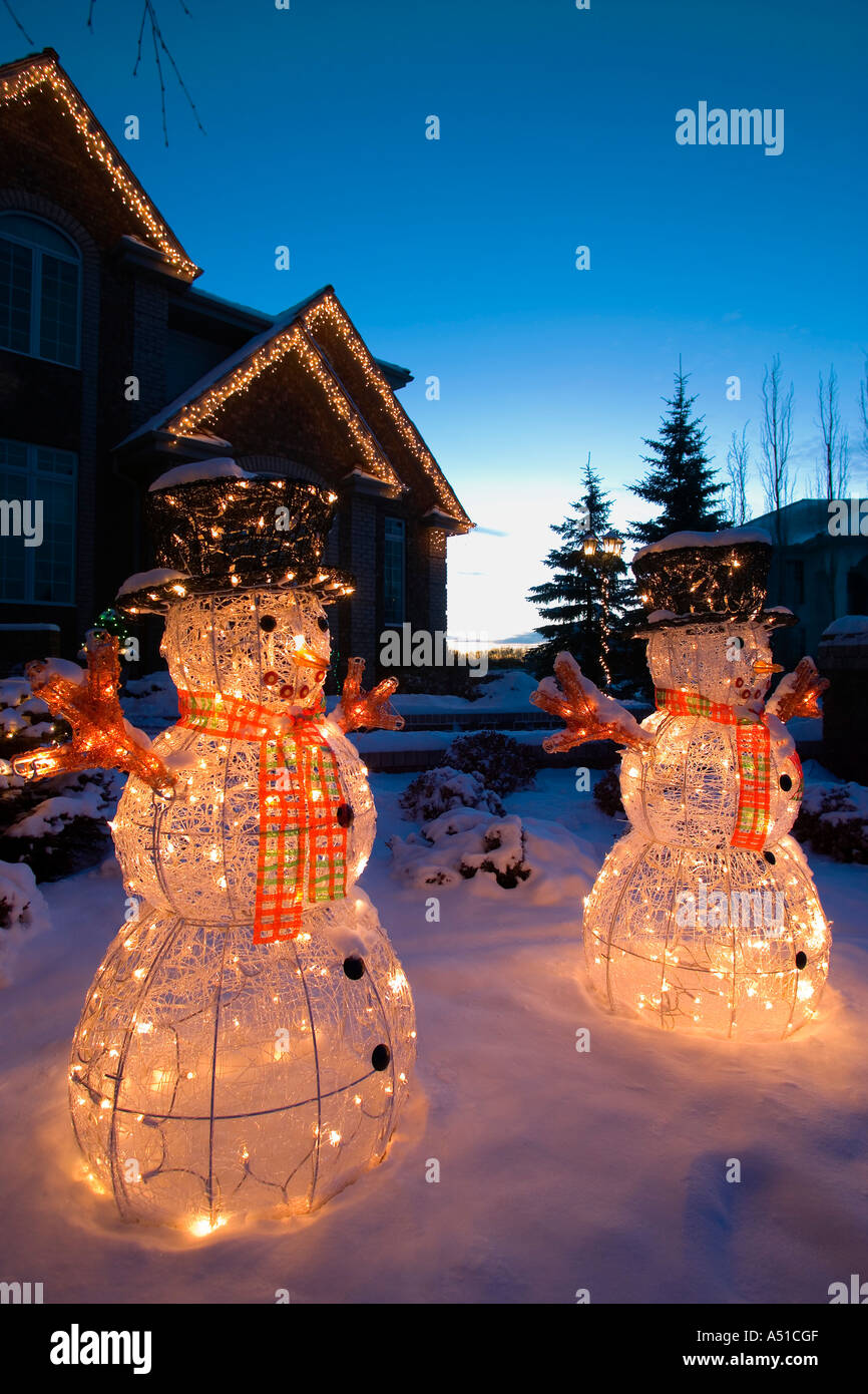 Illuminated Snowmen Outside House Stock Photo Alamy
