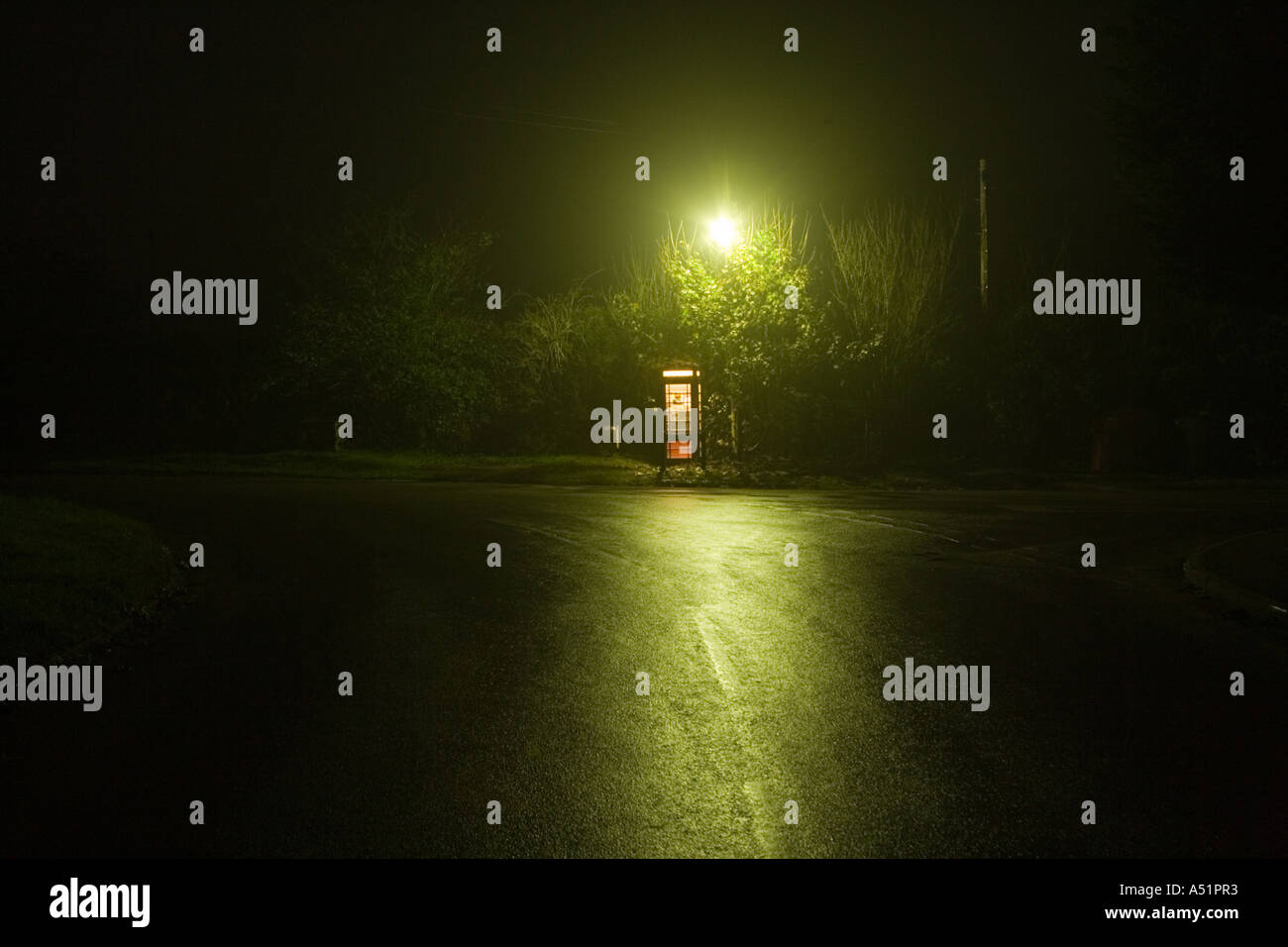 a telephone box under a street lamp in a remote village, UK Stock Photo