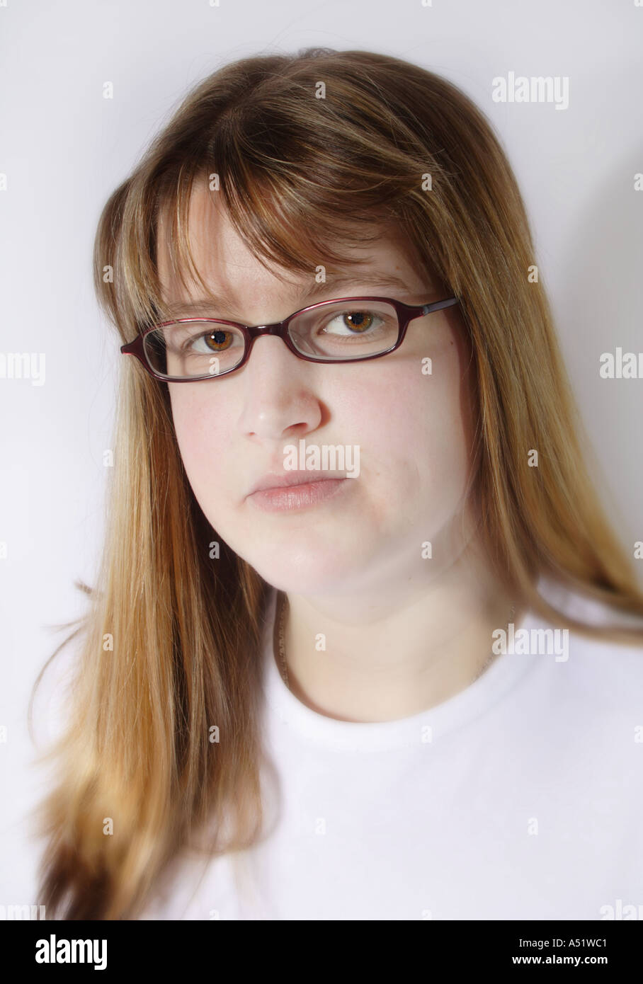 Young woman in her 20s with glasses looking pensive and serious Stock Photo