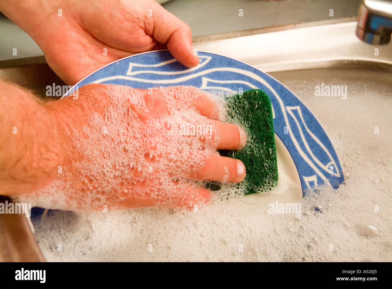 Man washing dishes by hand Stock Photo Alamy