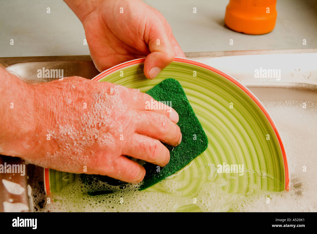 Man washing dishes by hand Stock Photo Alamy