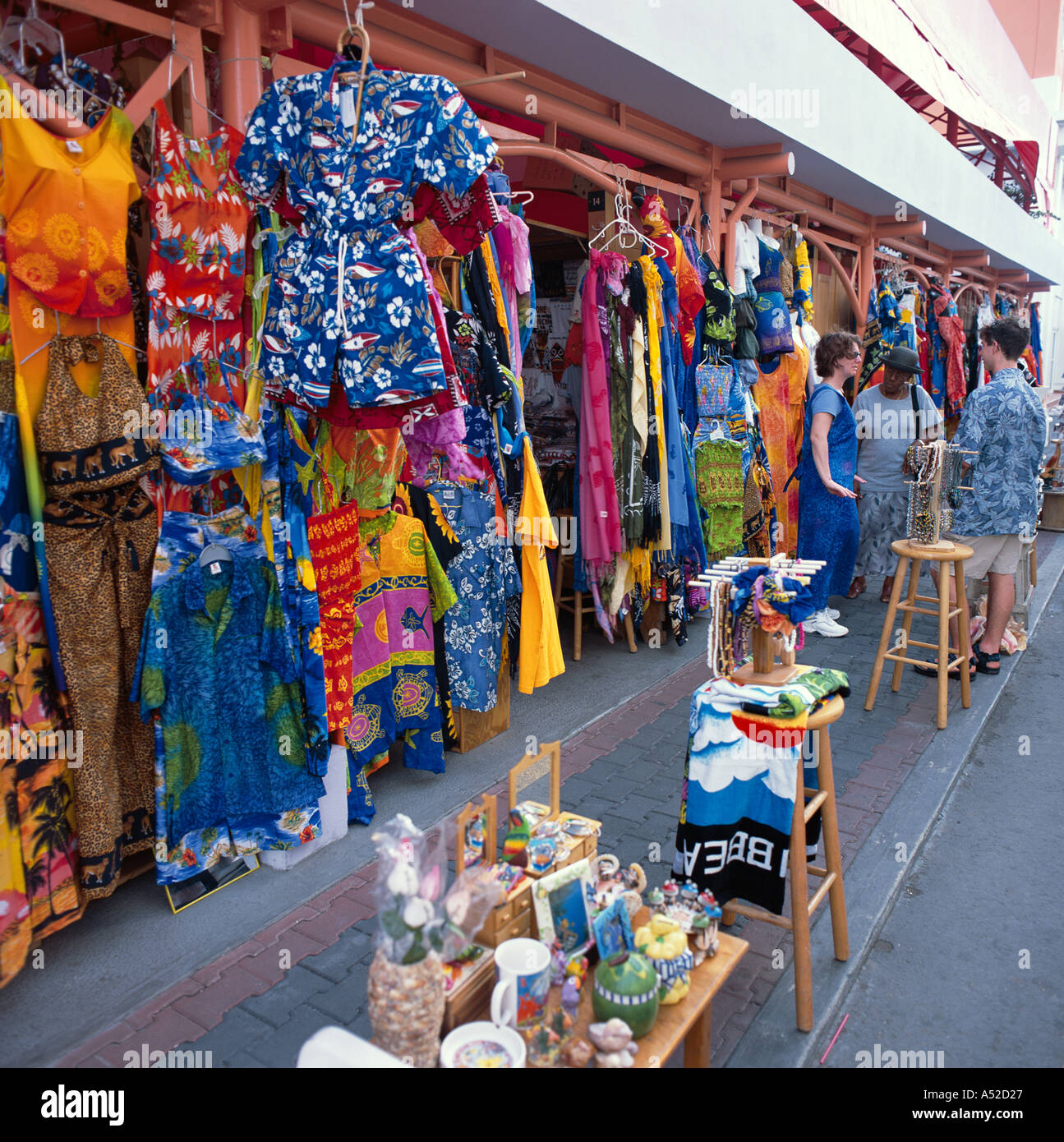 Line of market shop fronts with materials and dresses for sale in Redcliffe Quay St Johns the capital of Antigua The Caribbean Stock Photo